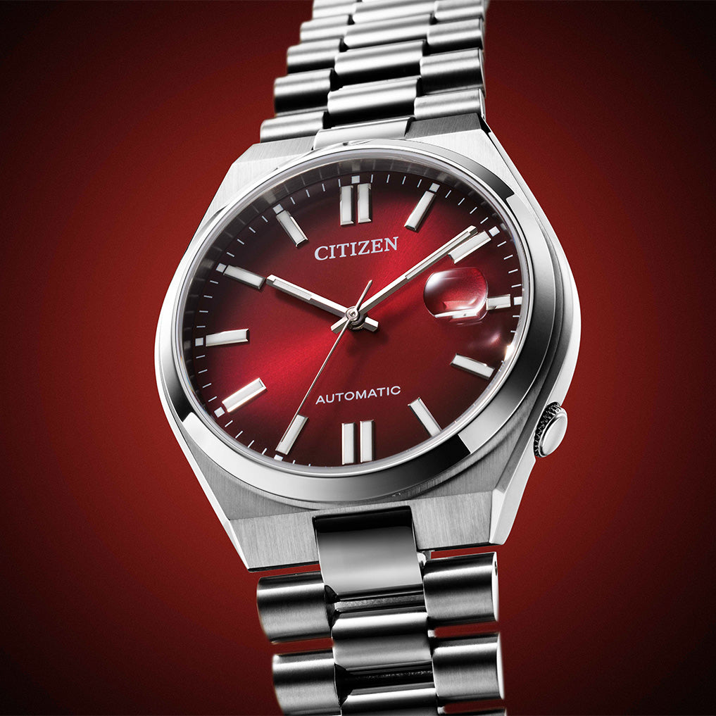 Silver Citizen watch with a red face on a gradient red background - Citizen