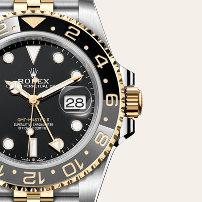 Rolex watch with black dial and gold and silver accents on a white -background  - Cassio