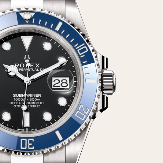 Close-up of a Rolex watch with black face, blue bezel, and silver case - DN Store - officialrivon