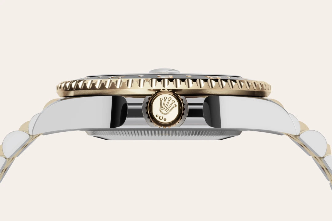 Close-up of a Rolex watch with a gold and silver band on a white background- Hublot